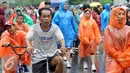 Sejumlah warga mengenakan jas hujan saat mengikuti kegiatan Car Free Day, Jakarta, Minggu (24/1/2016). Meski hujan mengguyur Ibu Kota sejak semalam, kegiatan CFD pagi di kawasan Bundaran Hotel Indonesia masih tetap ramai. (Liputan6.com/Helmi Affandi)