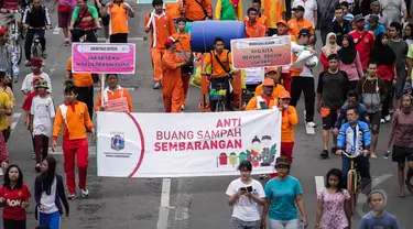 Sejumlah orang yang tergabung dari Dinas Kebersihan Jakarta menggelar aksi damai di Bundaran HI, Minggu (28/12/2014). (Liputan6.com/Faizal Fanani)