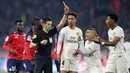 Para pemain Paris Saint-Germain (PSG), melakukan protes saat wasit memberikan kartu merah pada laga melawan Lille pada laga Liga Prancis di  Stade Pierre Mauroy, Minggu (14/4). PSG takluk 1-5 dari Lille. (AP/Michel Spingler)