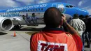 Salah satu karyawan maskapai penerbangan Brasil mengambil gambar pesawat Aerolineas Argentinas, yang akan membawa tim nasional sepak bola Argentina ke Brasil untuk Piala Dunia 2014, di Bandara Ezeiza, Buenos Aires, (3/6/2014). (REUTERS/Marcos Brindicci)