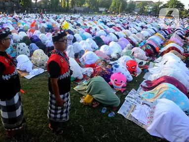 Pecalang dari Banjar Pegok berjaga saat umat muslim melakukan Sholat Idul Fitri di Lapangan Pegok, Sesetan, Denpasar, Sabtu (22/4/2023). (merdeka.com/Arie Basuki)