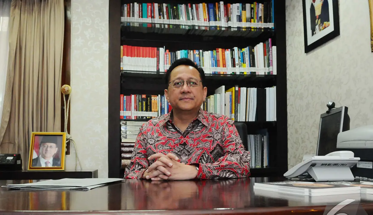 Ketua DPD RI, Irman Gusman mengenakan batik dengan warna dominan merah saat Liputan6.com berkunjung ke kediaman pribadinya, Jakarta, Rabu (3/12/2014). (Liputan6.com/Andrian M Tunay)