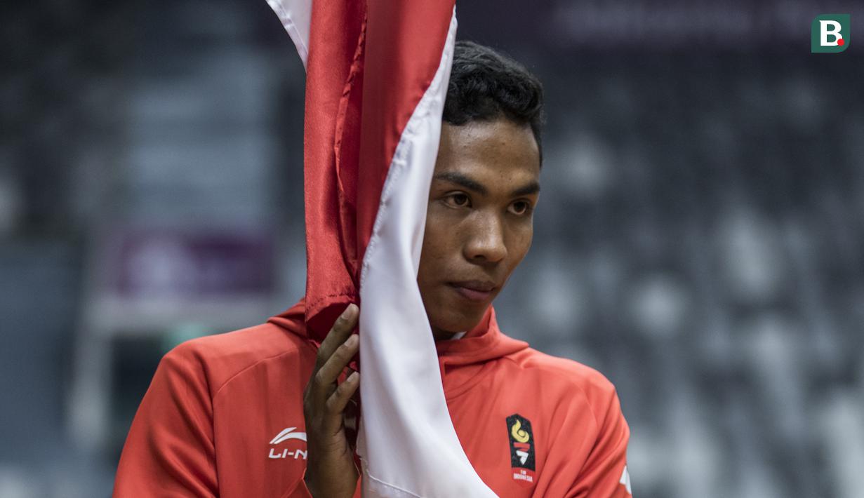 Pelari Indonesia, Lalu Zohri, usai mencium bendera saat acara pengukuhan kontingen Indonesia di Istora Senayan, Jakarta, Minggu (5/8/2018). Pada Asian Games XVIII, Indonesia menurunkan 938 atlet. (Bola.com/Vitalis Yogi Trisna)