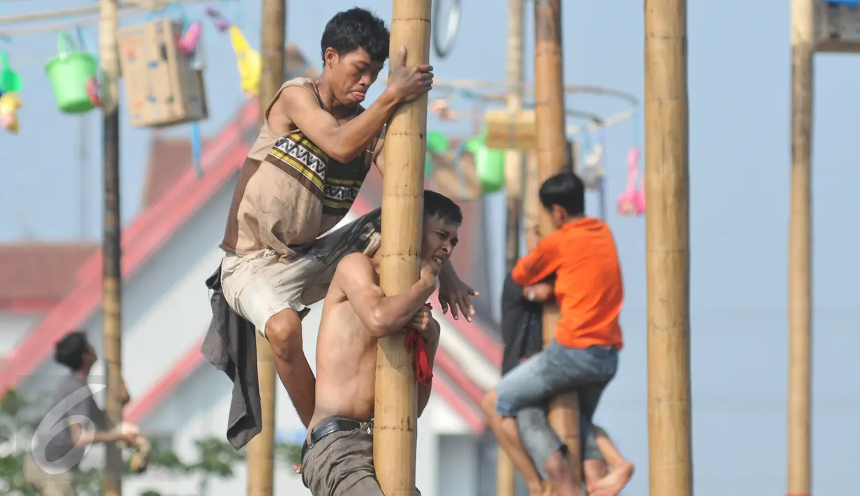 Sejumlah warga berebut memanjat pada lomba Panjat Pinang Kolosal dalam rangka merayakan HUT RI ke-70 di Pantai Karnaval, Ancol, Jakarta, Senin (17/8). Sebanyak 124 batang pinang disediakan dengan berbagai ragam hadiah. (Liputan6.com/Herman Zakharia)