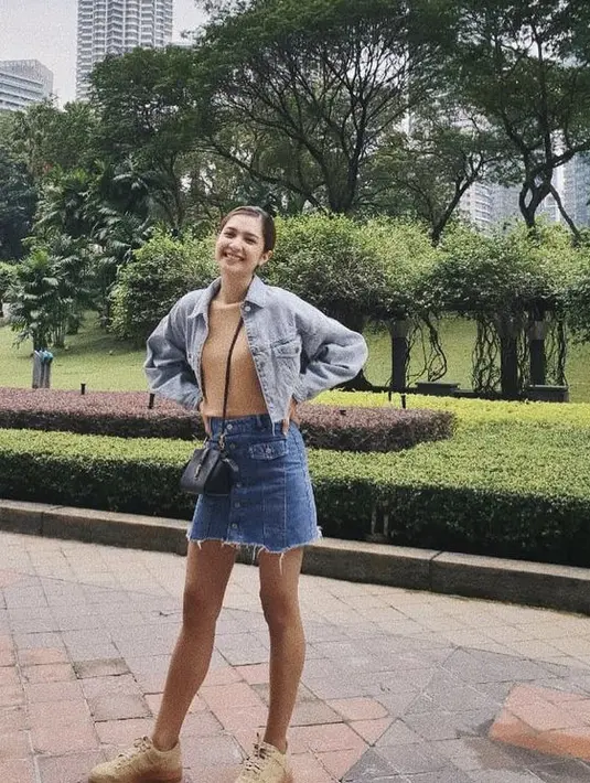 <p>Tampil santai dengan jaket jeans crop seperti Mikha Tambayong yang dipadu mini skirt jeans dan sneakers. Gunakan inner cokelat dan membawa sling bag. (@miktambayong)</p>