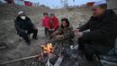 Kompor luar ruangan dan selimut yang diselamatkan dari rumah mereka sebagai satu-satunya sumber kehangatan. (Pedro Pardo / AFP)