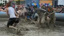 Wisatawan bermain di kolam lumpur selama Boryeong Mud Festival atau Festival Lumpur Boryeong di pantai Daecheon, Korea Selatan, Sabtu (20/7/2019). Festival ini dikenal sebagai festival paling populer di Korea Selatan dan berhasil mengundang ribuan turis dari seluruh penjuru dunia. (Minji SUH/AFP)