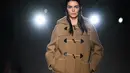 Kendall Jenner mempersembahkan kreasi Prada selama Koleksi Wanita Musim Gugur-Musim Dingin 2023-2024 sebagai bagian dari Fashion Week di Milan pada 23 Februari 2023. Kendall 27 tahun terlihat sangat luar biasa saat dia keluar dengan mengenakan mantel ransel unta. Mantel itu terbuka di bagian bawah untuk melihat sekilas kaki telanjang dan panjang bintang realitas itu. (AFP/Marco Bertorello)