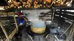 Seorang pria memasak air nira kelapa yang akan dijadikan gula merah di desa Taman Jaya, Sukabumi, Jawa Barat  (24/06). Dalam sehari warga dapat menghasilkan gula kelapa sekitar 20 kilogram. (Merdeka.com/Arie Basuki)