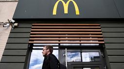 Seorang pria berjalan melewati restoran McDonald's yang tutup di Moskow, Rusia pada 16 Mei 2022. Raksasa makanan cepat saji asal Amerika, McDonald's, akan keluar dari pasar Rusia dan menjual bisnisnya di negara yang semakin terisolasi itu, kata perusahaan tersebut pada Senin kemarin. (Kirill KUDRYAVTSEV / AFP)