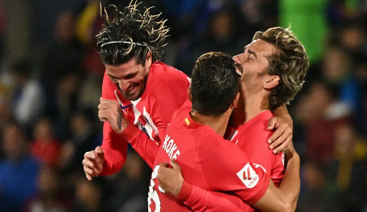 Penyerang Atletico Madrid, Antoine Griezmann (kanan) merayakan gol kedua timnya saat pertandingan sepak bola Liga Spanyol melawan Getafe CF di stadion Coliseum Alfonso Perez, Getafe, 15 Mei 2024. (JAVIER SORIANO/AFP)