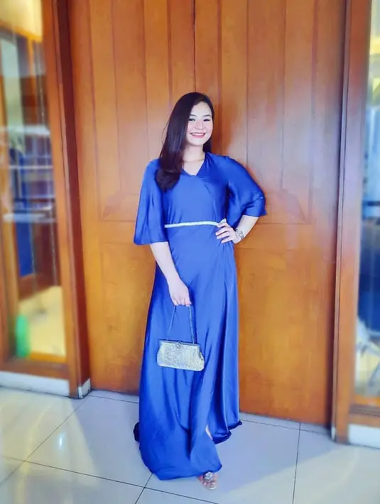 <p>Eriska Rein menunjukkan sisi glamornya dengan maxi dress berwarna biru. Potongan lengan terompet dan belt menjadi solusi praktis bagi bumil yang tidak percaya diri dengan ukuran lengan besar. (instagram/eriskarein)</p>