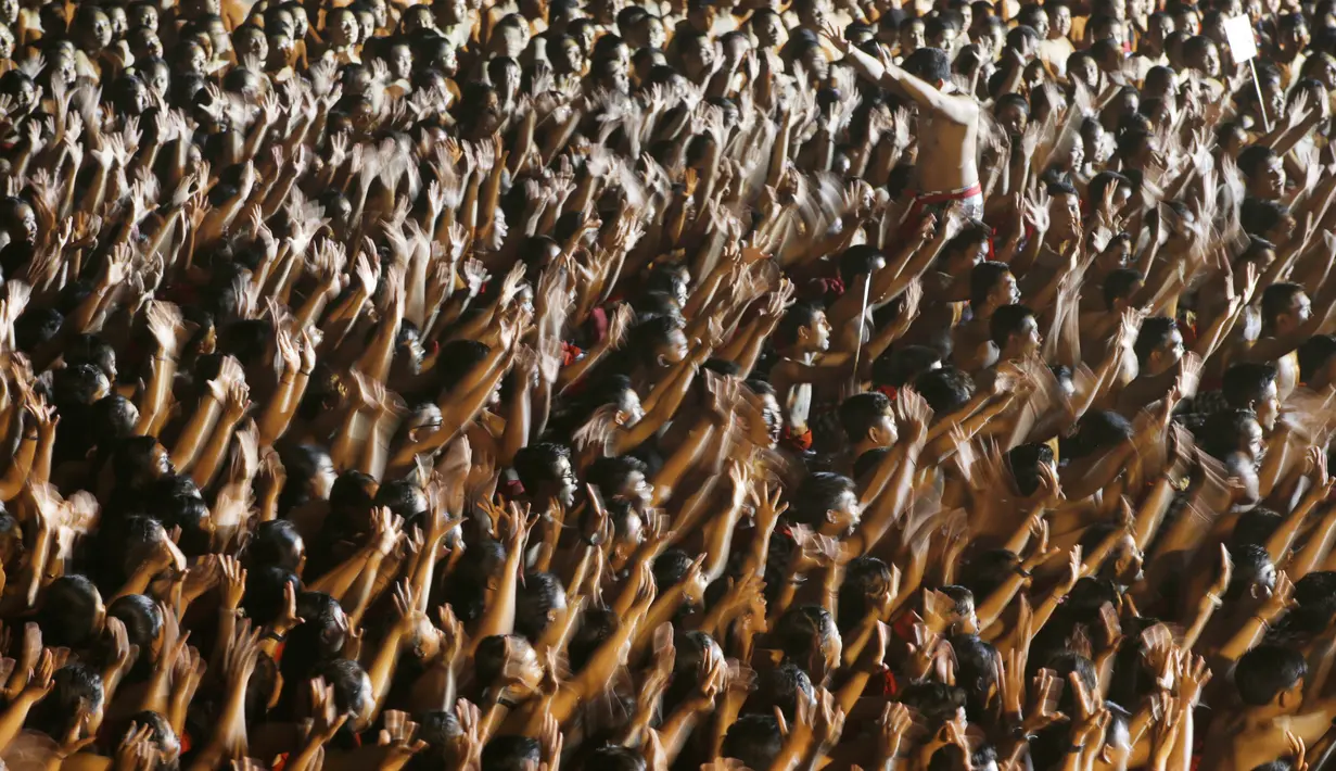 Ribuan pelajar menampilkan Tari Kecak Kolosal di Pantai Berawa, Badung, Bali, Minggu (25/2). Tarian yang melibatkan 5.555 penari tersebut memecahkan rekor dunia Tari Kecak Kolosal dengan peserta terbanyak. (AP/Firdia Lisnawati)