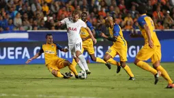 Penyerang Tottenham Hotspur, Harry Kane berusaha melewati beberapa pemain APOEL Nicosia pada grup H Liga Champions di stadion GSP, Nicosia, Siprus (26/9).Tottenham menang telak 3-0 atas APOEL Nicosia. (AP Photo/Petros Karadjias)