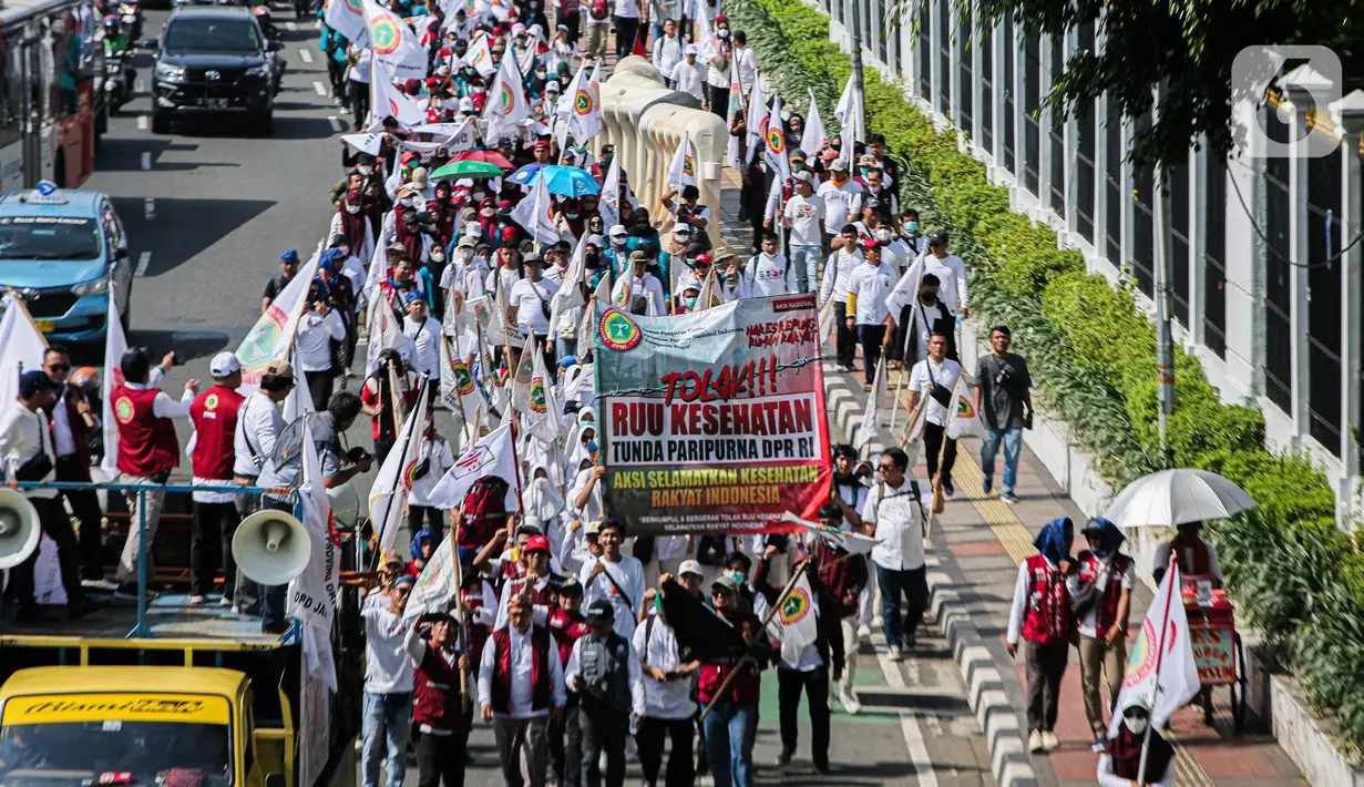 Beberapa anggota massa membawa spanduk bertuliskan 'Stop Pembahasan RUU Kesehatan: Ancaman Kriminalisasi Medis dan Tenaga Kesehatan'. (Liputan6.com/Faizal Fanani)