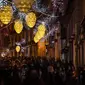 Orang-orang berjalan di bawah lampu Natal di Chiado di Lisbon (17/12). (AFP Photo/Patricia De Melo Moreira)