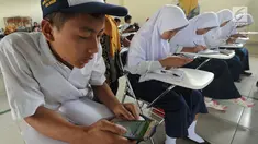 Pelajar menggunakan ponsel android mengikuti babak penyisihan lomba matematika dengan metode Gasing (Gampang Asyik & Menyenangkan) di SMKN 1 Leuwiliang, Bogor, Selasa (8/1). (Merdeka.com/Arie Sunaryo)