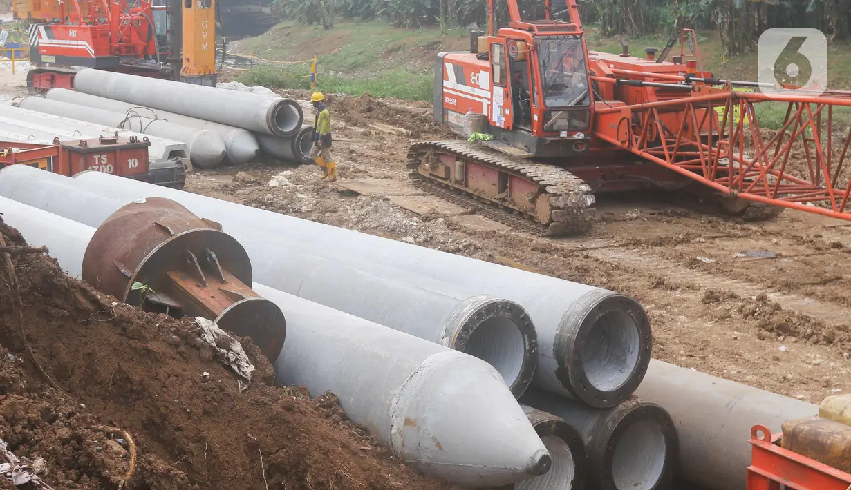 Aktivitas pekerja proyek Pembangunan Sistem Pengambilan dan Treatment Sampah Badan Air melalui Rekayasa Sungai pada Kali Ciliwung segmen TB Simatupang di kawasan Pasar Rebo, Jakarta, Senin (26/9/2022). Teknologi yang digunakan merupakan teknologi terbaru yang dimiliki Pemprov DKI dengan saringan sampah yang tidak hanya dapat mengambil sampah yang berada di badan air, namun sampah yang telah diambil juga akan melalui proses pengolahan terlebih dahulu. (Liputan6.com/Herman Zakharia)