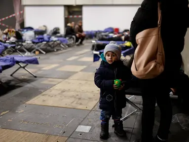 Seorang anak terlihat di pusat pengungsi yang baru tiba dari Ukraina di Messe di Berlin, Jerman pada 11 Maret 2022. Badan PBB untuk urusan pengungsi (UNHCR)mengatakan setidaknya 2,5 juta orang telah meninggalkan Ukraina, dengan lebih dari setengahnya sekarang di Polandia. (Odd ANDERSEN / AFP)