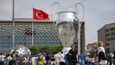 Pejalan kaki berjalan di dekat balon trofi Liga Champions  di Taksim Square di Istanbul, pada 8 Juni 2023. (AFP/Yasin Akgul)