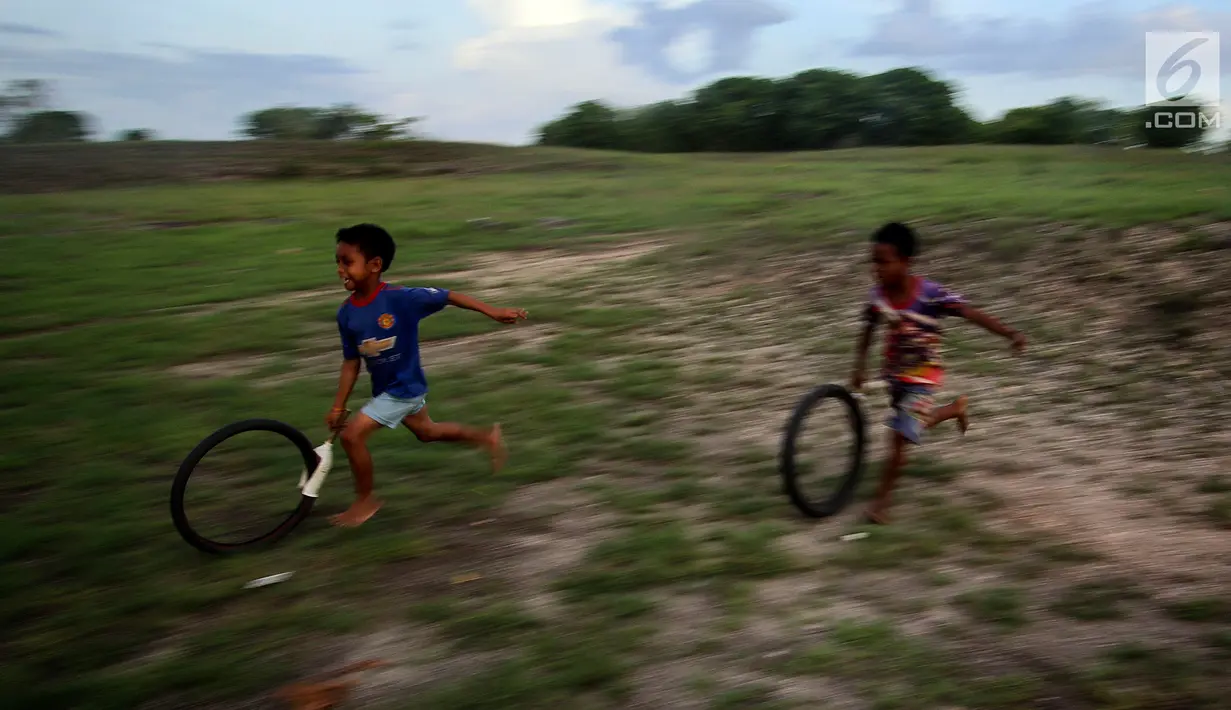 Anak-anak di desa Waimarang melakukan permainan tradisional. Permainan tradisional anak-anak di desa Waimarang menjadikan mereka anak-anak yang kreatif karena menciptakan alat permainan dari barang-barang di desa tersebut. (Liputan6.com/Johan Tallo)
