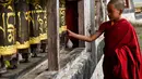 Seorang biksu muda saat memutar roda doa di biara Tawang. Ketika anak laki-laki bergabung dengan biara untuk menuntut ilmu, itu dengan syarat bahwa itu adalah komitmen seumur hidup. (AFP/Arun Sankar)