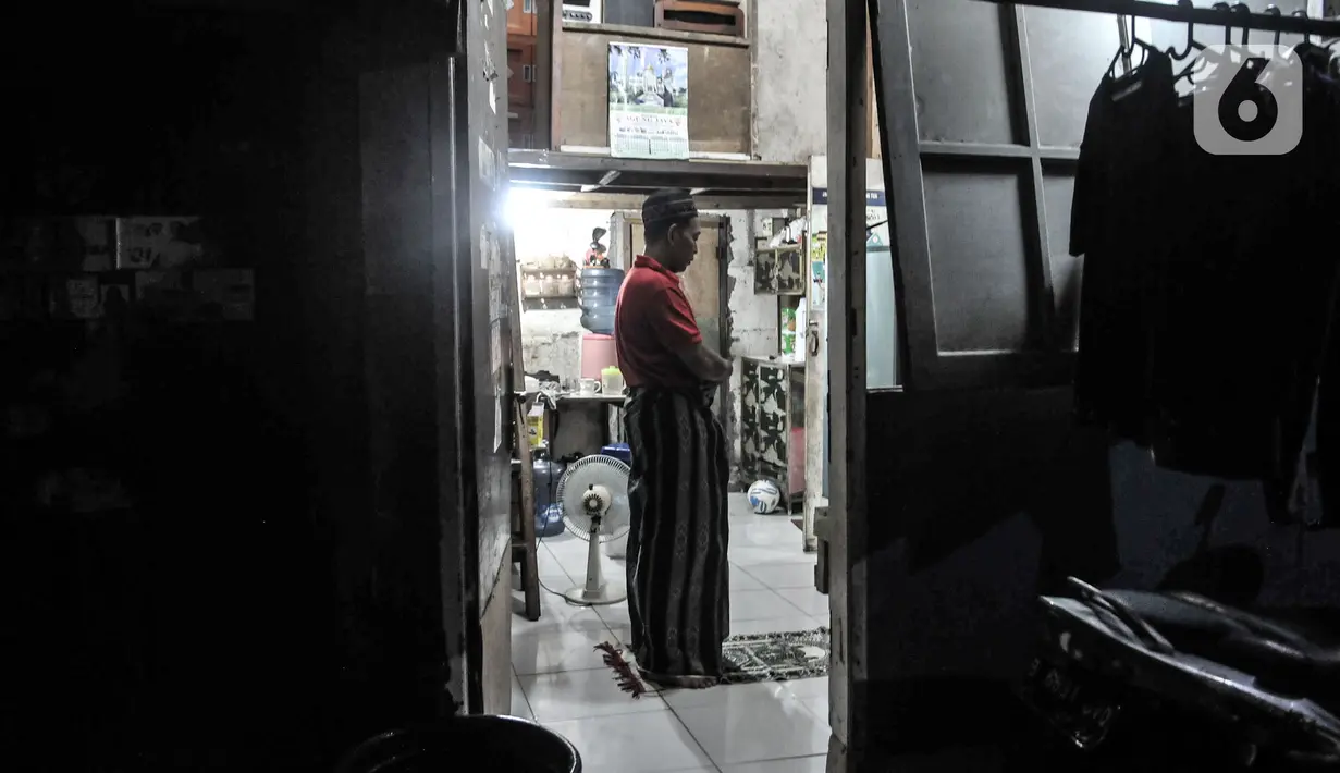 Seorang warga yang belum menerima uang kompensasi saat salat Magrib di rumahnya di Kampung Bayam, Kelurahan Papanggo, Tanjung Priok, Jakarta, Rabu (21/10/2020). (merdeka.com/Iqbal S. Nugroho)