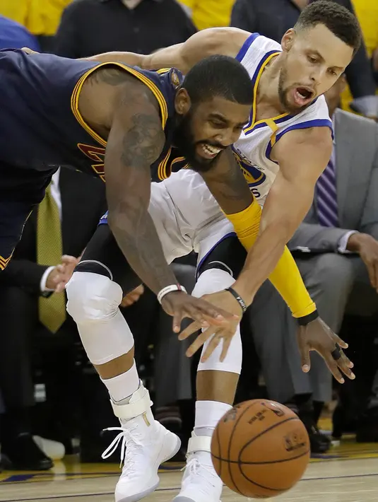 Stephen Curry (30) berebut bola dengan Kyrie Irving pada pertandingan  gim pertama Final NBA 2017 di Oracle Arena di Oakland, California (1/6). Curry mencatatkan double-double dengan 28 poin dan 10 assist. (AP Photo / Marcio Jose Sanchez)