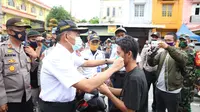 Menko PMK juga membagi-bagikan masker kepada masyarakat sekitar lingkungan kampus UMSU.