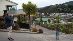 Wisatawan berfoto di tengah Baldwin Street, yang terkenal dengan jalan paling curam di dunia, di kota Dunedin, Selandia Baru, 26 Agustus 2017. Baldwin Street dikenal sebagai jalan paling curam di dunia menurut Guinness World Records. (AP Photo/Mark Baker)