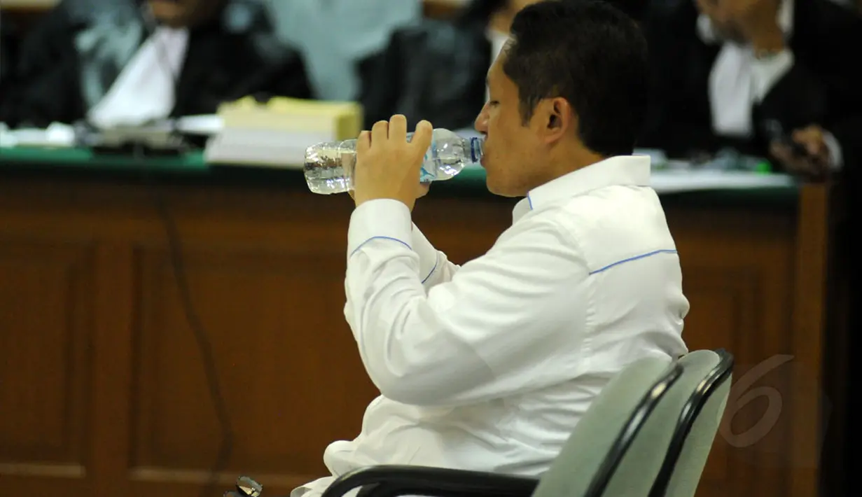 Anas Urbaningrum diberi waktu untuk minum disela-sela pembacaan nota pembelaan dirinya di Pengadilan Tipikor Jakarta, (18/9/2014). (Liputan6.com/Helmi Fithriansyah)