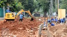 Sejumlah pekerja menyelesaikan pengerjaan saluran air di sekitar jalan Gerbang Pemuda, Jakarta, Senin (6/3). Pembuatan saluran air dan peningkatan pedestrian ini terkait pelaksanaan Asian Games 2018 mendatang. (Liputan6.com/Helmi Fithriansyah)