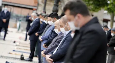 Warga yang mengenakan masker mengikuti salat Jumat, dengan menjaga jarak di depan sebuah masjid di Ankara, 29 Mei 2020. Masjid-masjid di seluruh Turki pada Jumat (29/5) kembali dibuka, sebagai bagian proses normalisasi di tengah melambatnya penyebaran COVID-19 di negara itu. (Xinhua/Mustafa Kaya)