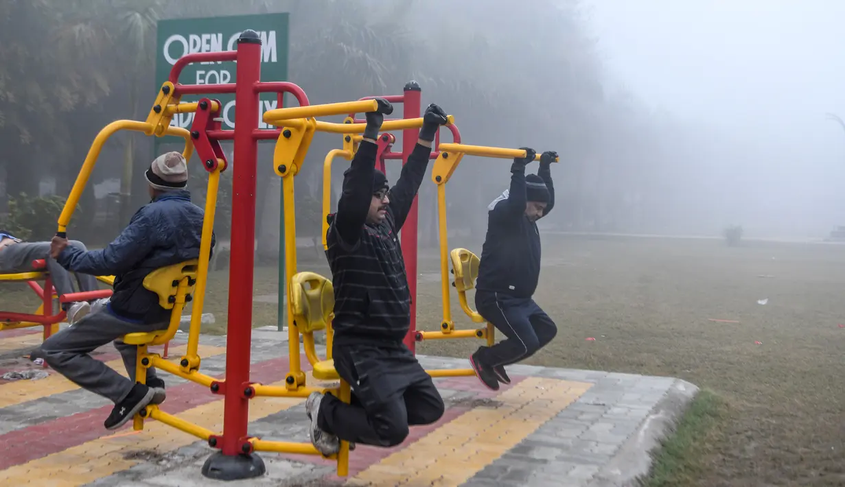 Orang-orang berolahraga di tengah kabut tebal selama hari yang dingin di sebuah taman di Amritsar, India (30/12/2019). India saat ini mengalami musim dingin dengan hari dingin terpanjang dalam 22 tahun terakhir. (AFP/Narinder Nanu)