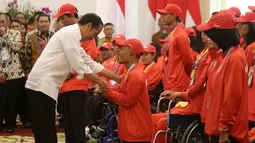 Presiden Joko Widodo memberikan bonus kepada atlet renang Asian Para Games 2018, Aris di Istana Bogor, Jakarta, Sabtu (13/10). Aris mendapat bonus sebesar Rp 500 juta karena memperoleh medali perunggu di Asian Para Games 2018. (Liputan6.com/HO/Randy)