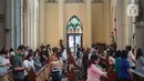 Jemaat duduk di antara pembatas jarak tubuh saat melaksanakan ibadah misa di Gereja Katedral Jakarta, Minggu (12/7/2020). Gereja Katedral Jakarta kembali menggelar misa bagi umat Katolik dengan menerapkan protokol kesehatan untuk mencegah penularan Covid-19. (Liputan6.com/Immanuel Antonius)
