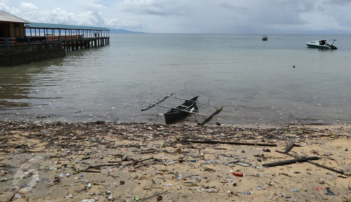 Sebuah sampan bersandar di tepi pantai yang dipenuhi sampah di Pulau Bunaken, Manado, Sabtu (17/12). Obyek wisata kelas dunia dari Sulawesi Utara itu sangat memprihatinkan saat ini. (Liputan6.com/Fery Pradolo)