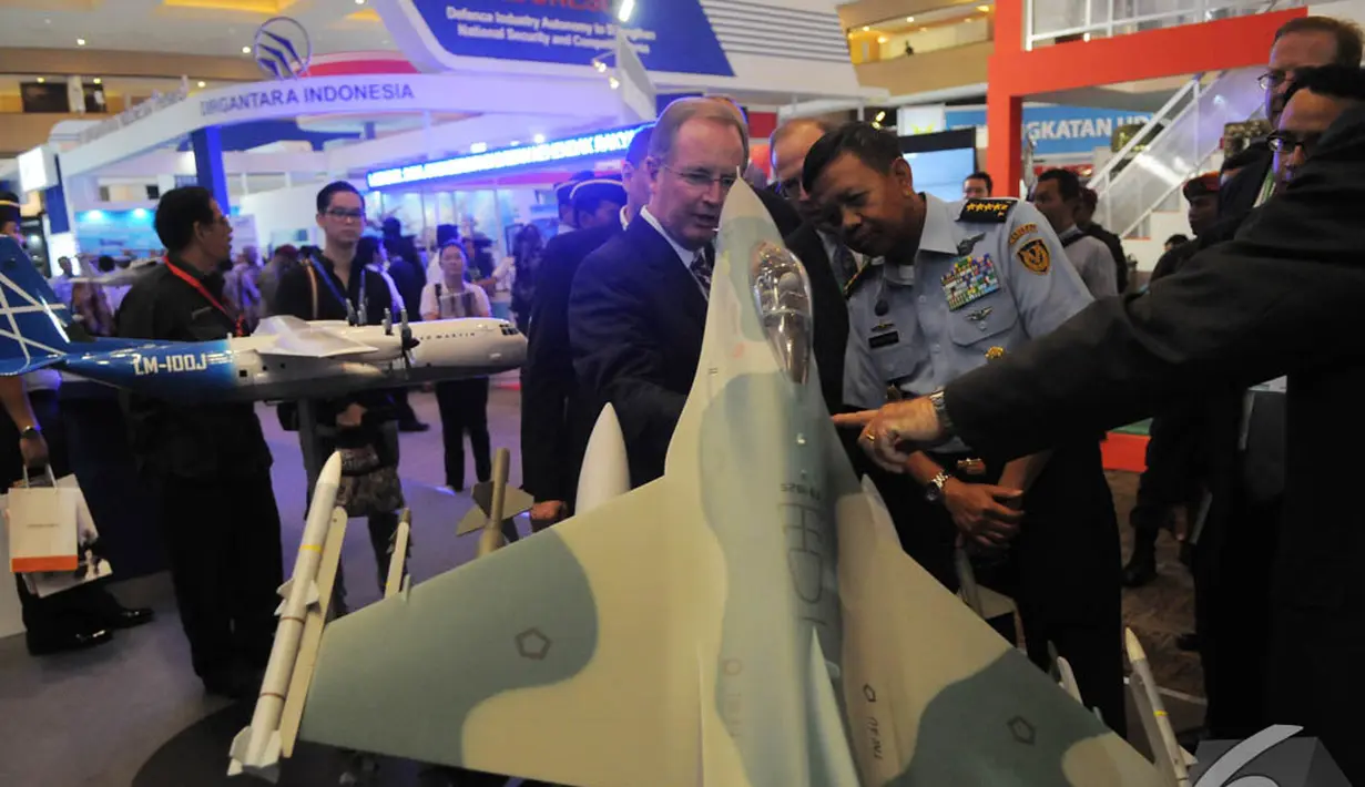 Para pengunjung melihat miniatur sebuah pesawat tempur di Indo Defence 2014, JIExpo Kemayoran, Jakarta, Rabu (5/11/2014)(Liputan6.com/Herman Zakharia)