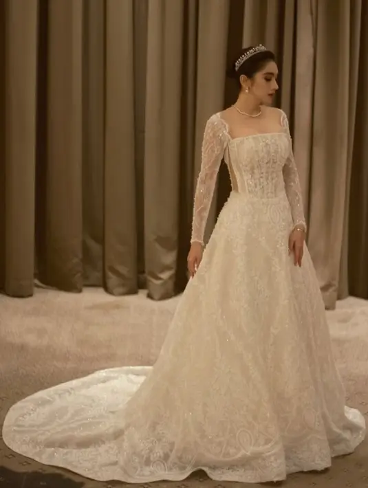 Angel Karamoy tampil mengenakan gaun ball gown warna putih. Gaun lengan panjang lace tersebut dihiasi beads yang indah. [@realangelkaramoy]