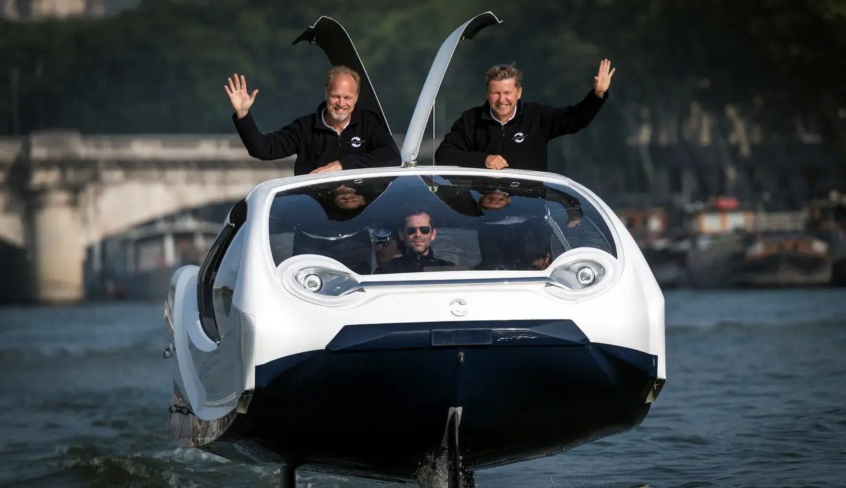 Pendiri Sea Bubbles Alain Thebault (kiri) dan Anders Bringdal (kanan) berdiri di atas kapal "flying taxi" Sea Bubble saat demonstrasi di sungai Seine di Paris, Prancis (20/5). (AFP Photo/Lionel Bonaventure)