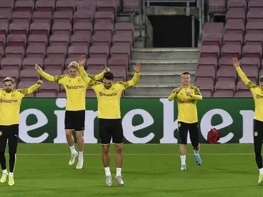Para pemain Borussia Dortmund melakukan pemanasan saat mengikuti sesi latihan di stadion Camp Nou di Barcelona (26/11/2019). Dortmund akan bertanding melawan Barcelona pada Grup F Liga Champions. (AFP Photo/Josep Lago)