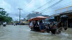 Delman menjadi alat transportasi pilihan warga saat banjir melanda kawasan Jalan KH Hasyim Ashari, Ciledug, Kota Tangerang, Selasa (10/2/2015). (Liputan6.com/Andrian M Tunay)