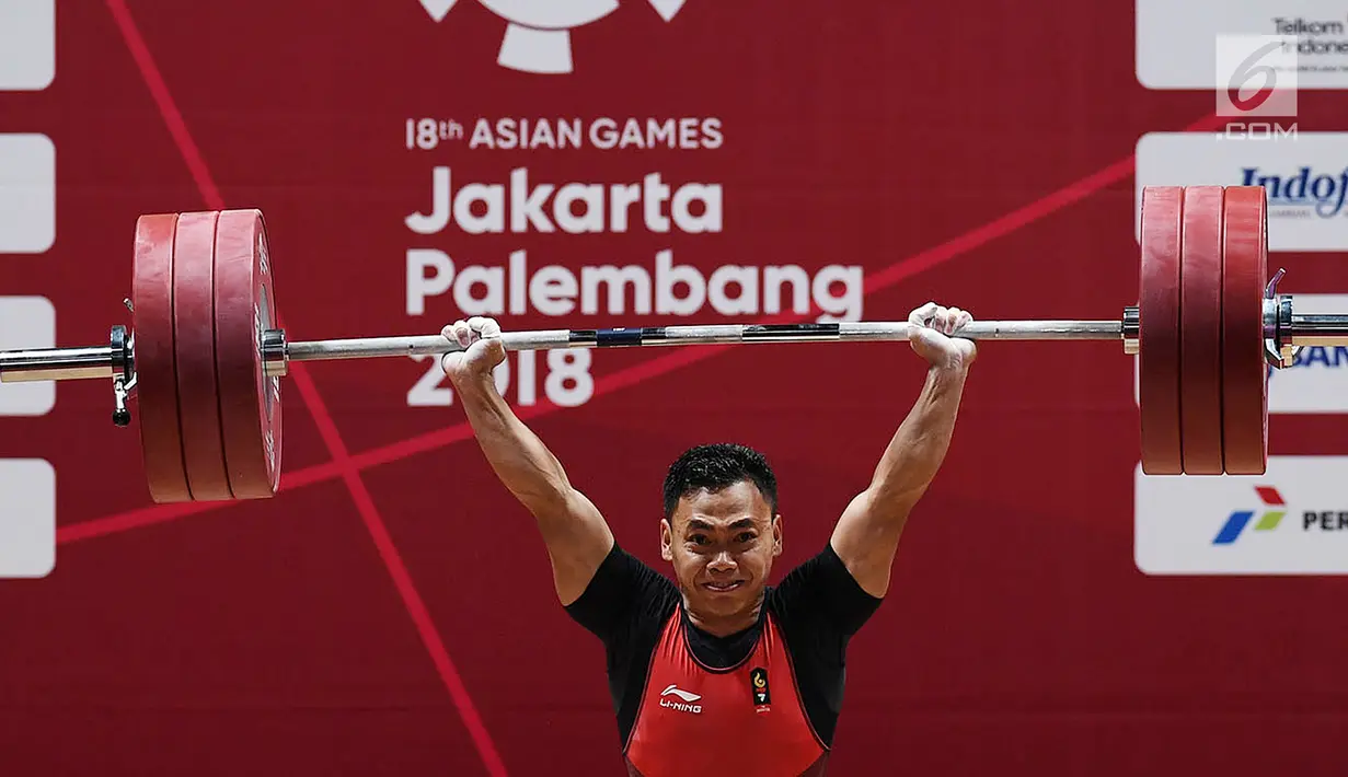 Eko Yuli menambah emas kelima di Asian Games 2018, setelah menjadi juara di kelas 62 kilogram putra dan meraih medali emas dengan total angkatan 311 kilogram. (merdeka.com/Imam Buhori)