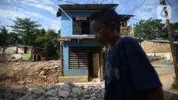 Seorang anak berjalan di bongkaran rumah yang terdampak normalisasi sungai Ciliwung  Rawajati, Jakarta, Rabu (16/11/2022). Pemprov DKI Jakarta kembali melanjutkan normalisasi kali Ciliwung Kelurahan Rawajati menjadi prioritas penanganan banjir pada 2023.  Dengan luas lahan yang dibebaskan sebesar 4.780 meter persegi dengan jumlah 22 kk. (merdeka.com/Imam Buhori)
