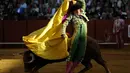 Matador Peru, Andres Roca Rey menghindari tandukan banteng di arena adu banteng Maestranza di Sevilla pada 15 April 2016. (AFP PHOTO / CRISTINA QUICLER)