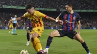 Robert Lewandowski (kanan) berusaha merebut bola saat Barcelona diimbangi Girona pada lanjutan Liga Spanyol (AFP)