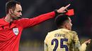 Wasit Srdjan Jovanovic (kiri) memberikan kartu merah kepada pemain FC Porto, Otavio da Silva dalam pertandingan leg pertama babak 16 besar Liga Champions 2022/2023 yang berlangsung di San Siro, Milan, Kamis (23/2/2023) WIB. (AFP/Marco Bertorello)