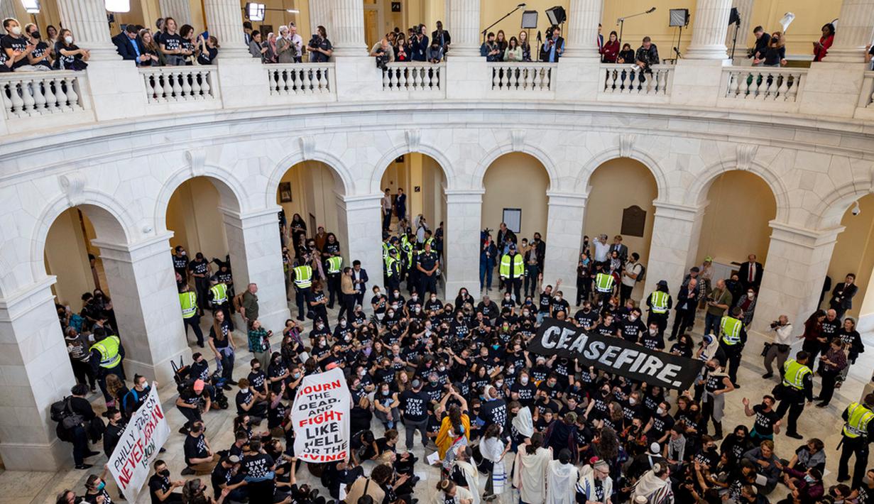 Para pengunjuk rasa menduduki Gedung Kongres Amerika Serikat (AS), membentangkan spanduk besar bertuliskan "Gencatan Senjata" sambil dikepung oleh polisi. (AP Photo/Amanda Andrade-Rhoades)