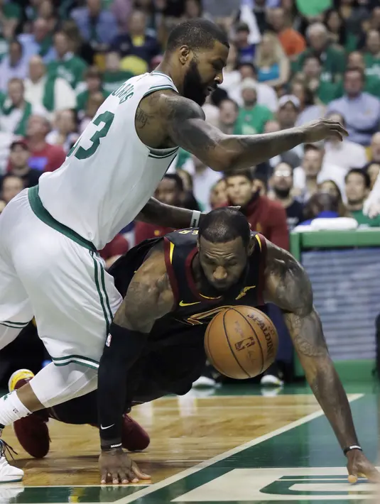 Pemain Cleveland, LeBron James (23) jatuh saat berebut bola dengan pemain Boston, Marcus Morris (13) pada gim kelima final NBA Wilayah Timur di TD Garden, Boston, (23/5/2018). Boston Celtics menang 96-83. (AP/Charles Krupa)
