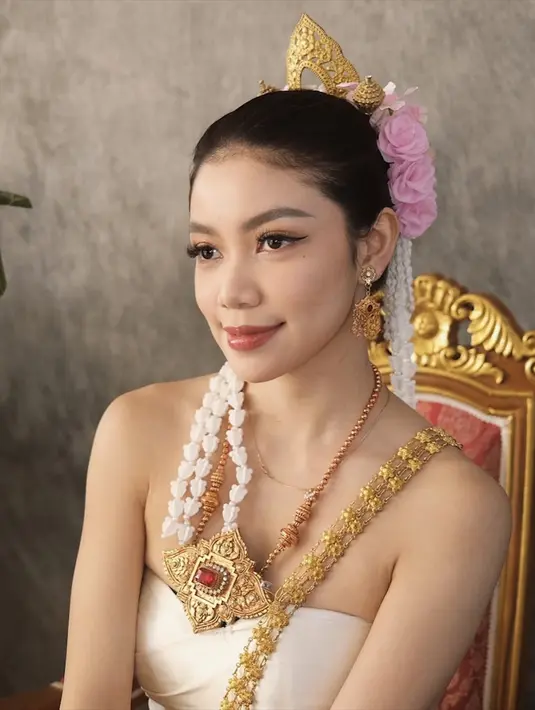 Rambut Regina disanggul rapi dengan hiasan bunga berwarna merah muda dan untaian melati putih, memberikan tampilan yang klasik dan anggun. Foto-foto ini tidak hanya menangkap keindahan budaya Thailand, tetapi juga menunjukkan pesona Regina Phoenix yang memikat. Momen ini menjadi kenangan berharga bagi Regina dan penggemarnya, menciptakan kesan mendalam tentang keindahan budaya dan keanggunan wanita Indonesia.  (Liputan6.com/IG/@reginaaphx)